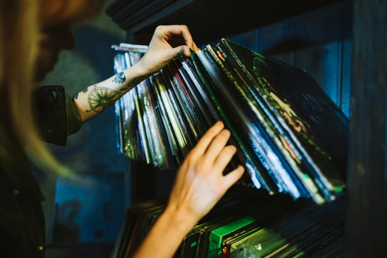 a woman holding a stack of vinyl records, trending on pexels, hands reaching for her, inspect in inventory image, thumbnail