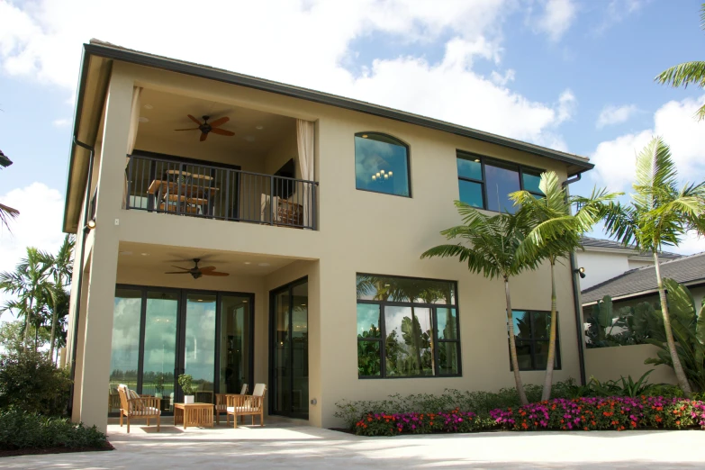 a house with a lot of windows and a balcony, with palm trees in the back, black windows, sun coast, award winning contemporary