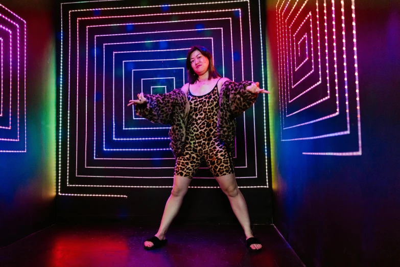 a woman in a leopard print dress standing in front of neon lights, in the magic room, laserpunk fullbodysuit, joy ang, doing a sassy pose