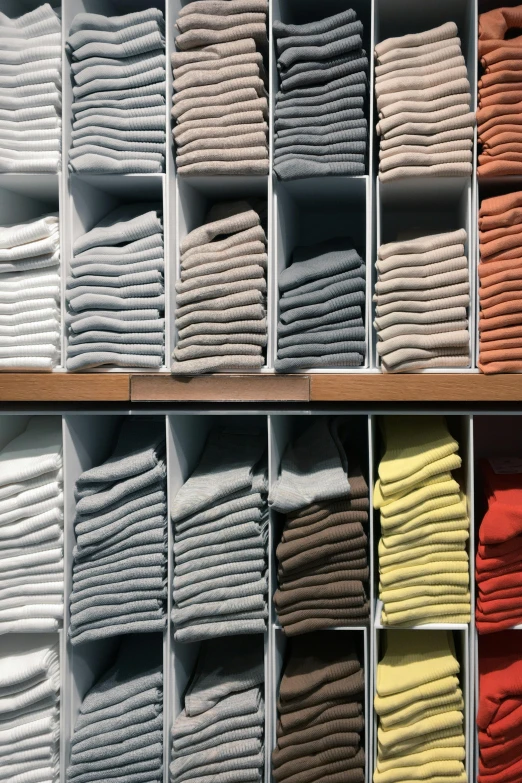 a shelf filled with lots of different colored shirts, inspired by Donald Judd, bauhaus, towels, zoomed in, high-quality photo, slide show