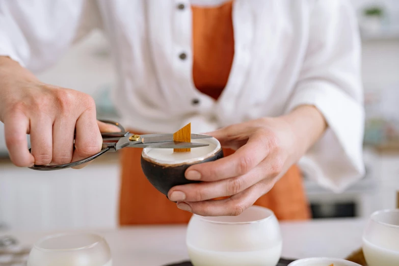 a close up of a person using a pair of scissors, a still life, inspired by Charles Le Roux, trending on pexels, molecular gastronomy, aussie baristas, bowl, white