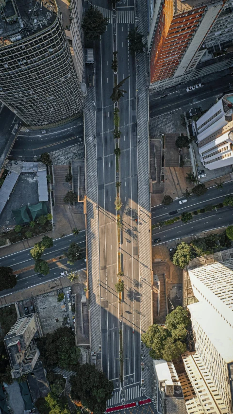 an aerial view of a city with tall buildings, by Alejandro Obregón, unsplash contest winner, photorealism, overpass, chile, road, flattened