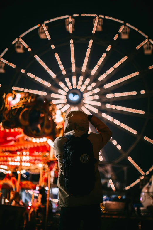 a man standing in front of a ferris wheel at night, unsplash contest winner, camera looking up at her, photo from behind of a cowboy, curiosities carnival fallout, profile image