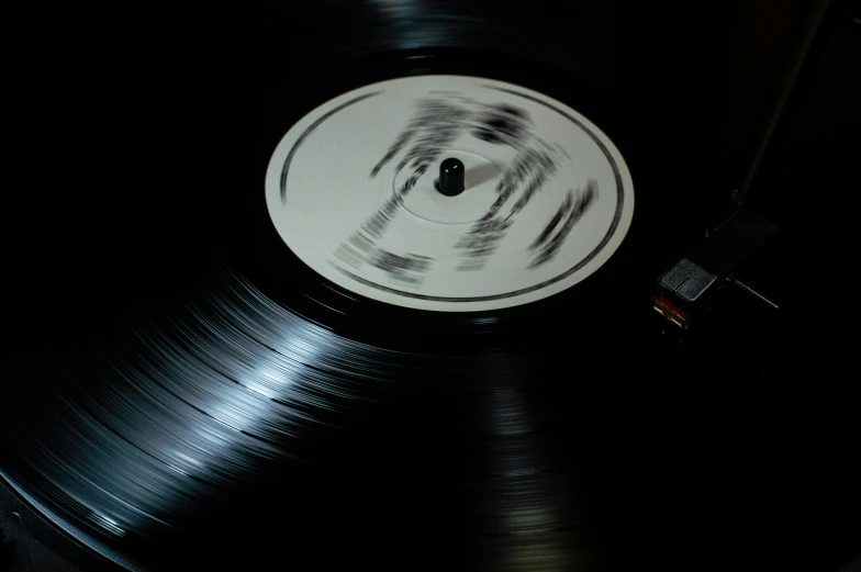 a close up of a vinyl record on a table, an album cover, by Doug Ohlson, pexels contest winner, hyperrealism, spinning whirlwind, (night), 15081959 21121991 01012000 4k, white stripes all over its body