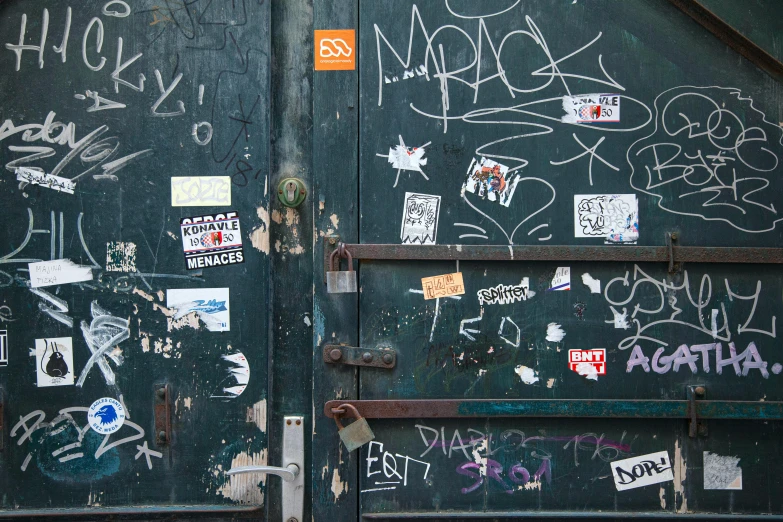a door with a bunch of stickers on it, an album cover, pexels, graffiti, scratched photo, more, 1 6 9 5, hardware
