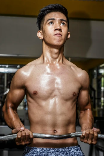 a shirtless man holding a barbell in a gym, an album cover, by Byron Galvez, pexels contest winner, asian hyperdetailed, he is about 20 years old | short, wearing tanktop, oily skin