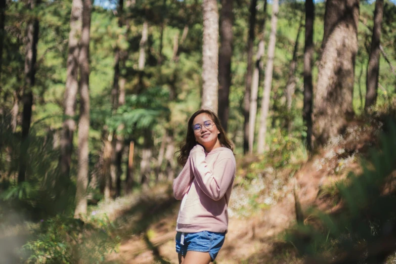 a woman standing in the woods talking on a cell phone, a portrait, unsplash, woman with rose tinted glasses, asian women, full body photo, girl standing on mountain