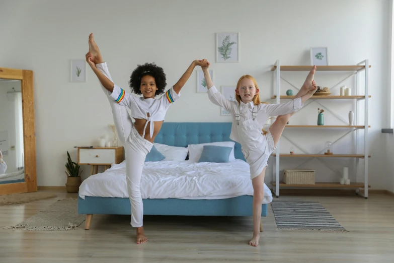 a couple of kids jumping on top of a bed, pexels contest winner, arabesque, kundalini energy, cottagecore!! fitness body, girl's room, dancing a jig