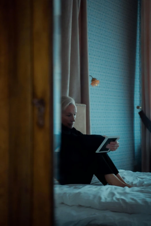 a person sitting on a bed reading a book, inspired by Elsa Bleda, cinematic shot ar 9:16 -n 6 -g, high quality upload, a blond, ignant