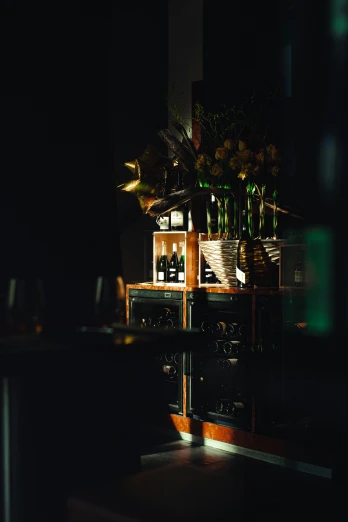 a vase of flowers sitting on top of a table, cozy dark 1920s speakeasy bar, green ambient light, clubs, instagram post