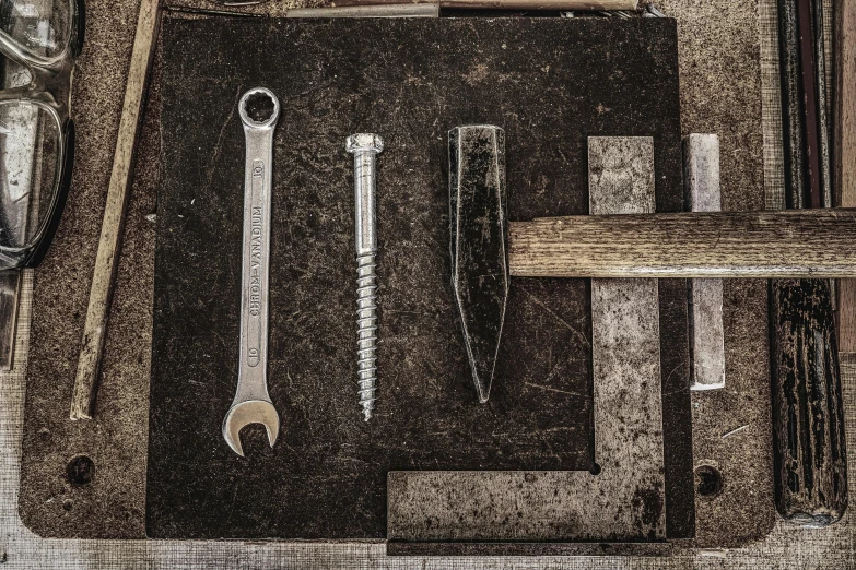 a bunch of tools sitting on top of a table, a still life, inspired by Constantin Hansen, unsplash, assemblage, exposing screw, john pawson, 1900s photo, white metal