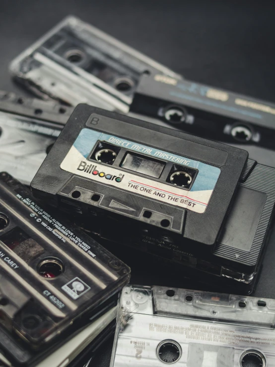 a pile of cassettes sitting on top of each other, an album cover, unsplash, multiple stories, vintage footage, music notes, old computers