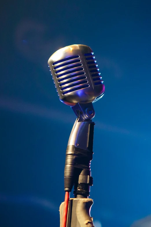 a close up of a microphone on a stand, an album cover, pexels, happening, large tall, blues, vivacious, no - text no - logo