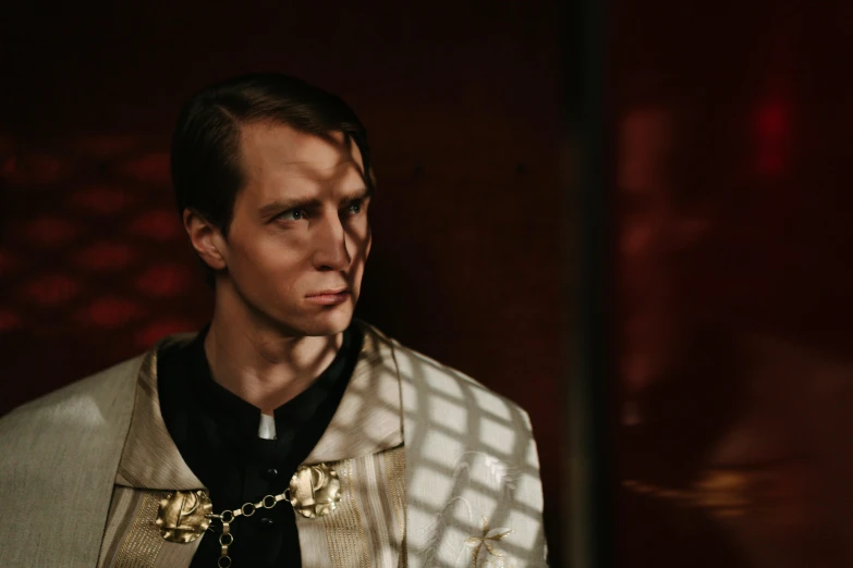 a close up of a person wearing a suit and tie, an album cover, inspired by Matthias Stom, wearing gilded robes, perfectly lit. movie still, cage, white russian clothes