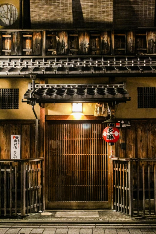 a building with a clock on the front of it, inspired by Kanō Shōsenin, trending on unsplash, ukiyo-e, dimly lit cozy tavern, gate, ( ( theatrical ) ), doorway