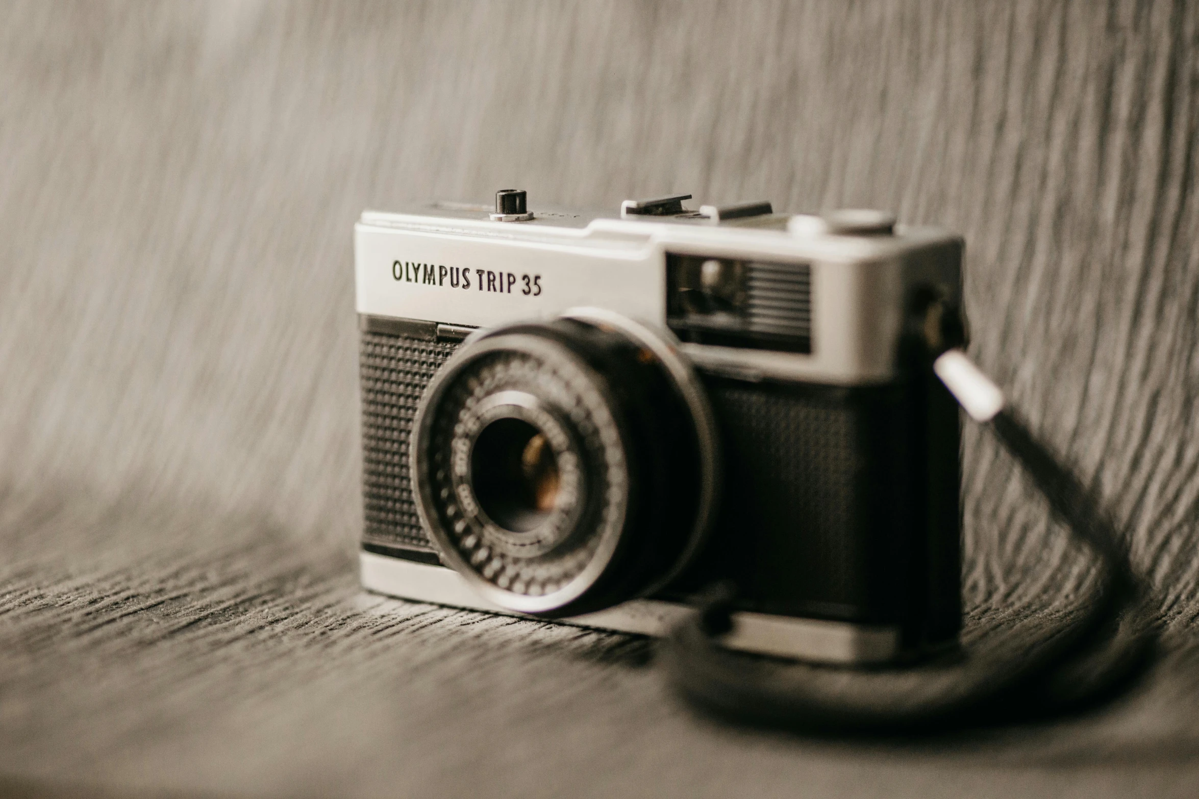 a black and white photo of a camera, unsplash contest winner, photorealism, olympus, sepia toned, 35mm of a very cute, coloured film photography