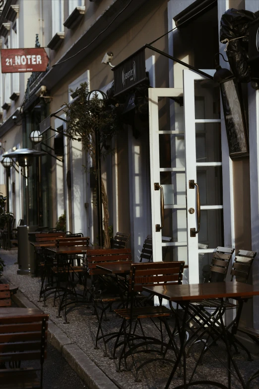 a row of tables sitting on the side of a street, inspired by Albert Paris Gütersloh, art nouveau, patio, old town, exterior view, 1997 )