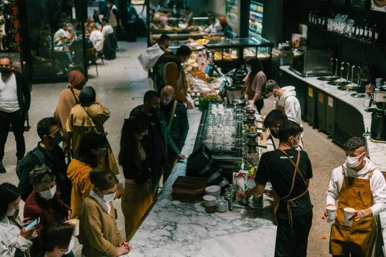 a group of people standing around a counter, by Nick Fudge, pexels contest winner, renaissance, central station in sydney, starbucks, ready to eat, demna gvasalia