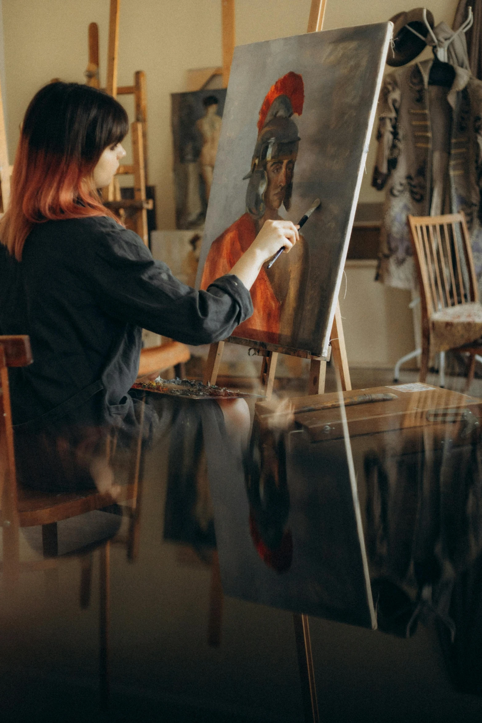 a woman that is sitting in front of a painting, painting a canvas, paint-on-glass painting, on canvas, trending on artstatioin