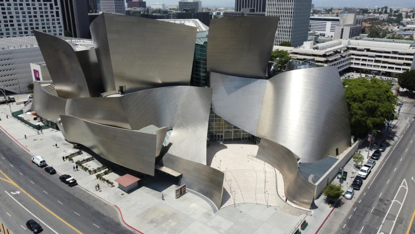 an aerial view of a modern building in a city, an abstract sculpture, inspired by david rubín, concert hall, lucasfilm, curved body, front facing