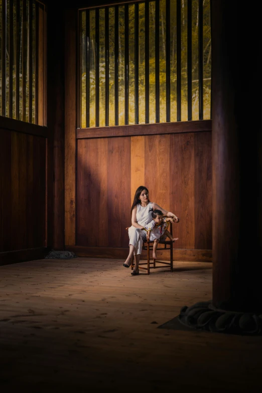 a woman sitting in a chair in a room, inspired by Kanō Shōsenin, art photography, stood outside a wooden cabin, production photo, wide view cinematic lighting, mai anh tran