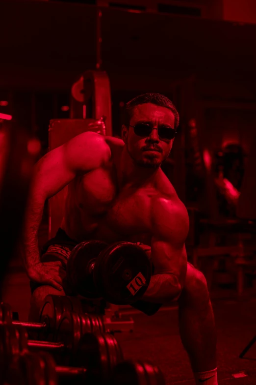 a man lifting a barbell in a gym, an album cover, by Adam Marczyński, pexels contest winner, cinematic and dramatic red light, thiago alcantara, shades of red, with abs