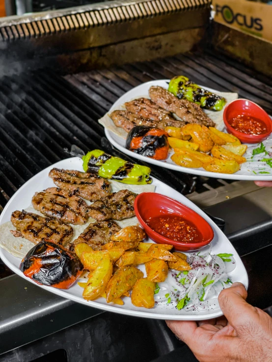 two plates of food being served on a grill, dau-al-set, high quality product image”