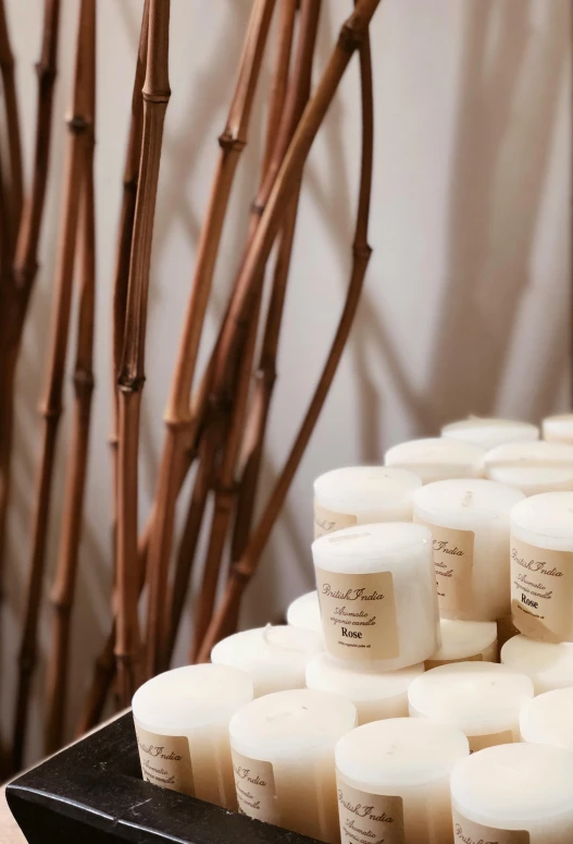 a bunch of candles sitting on top of a table, product display, lots of white cotton, “ iron bark, ivory towers