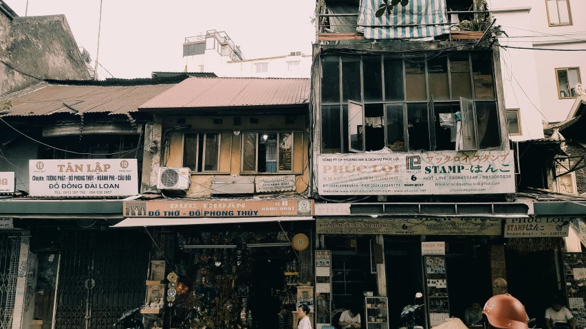 a group of people standing in front of a building, a photo, old shops, hoang lap, vsco, 🦩🪐🐞👩🏻🦳