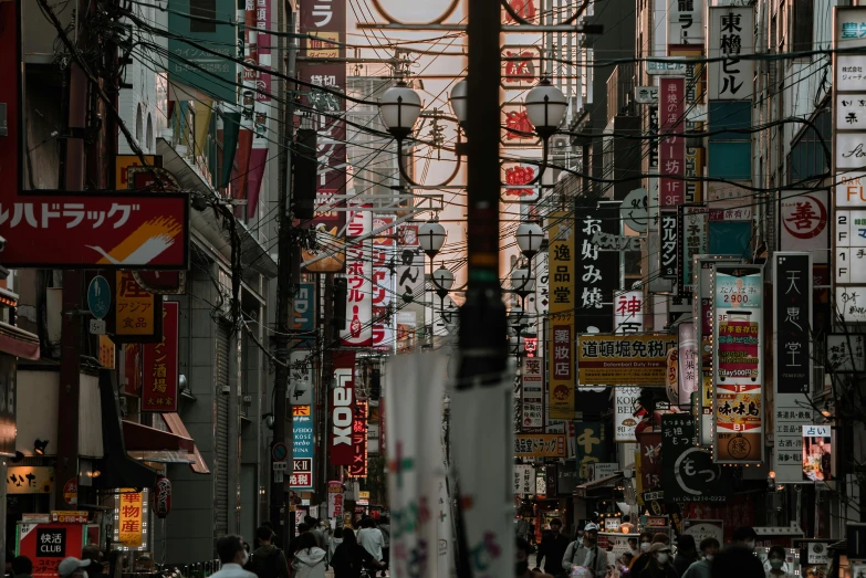 a group of people walking down a street next to tall buildings, inspired by Kanō Hōgai, pexels contest winner, ukiyo-e, lots of cables and neon signs, square, old japanese street market, photo of a beautiful