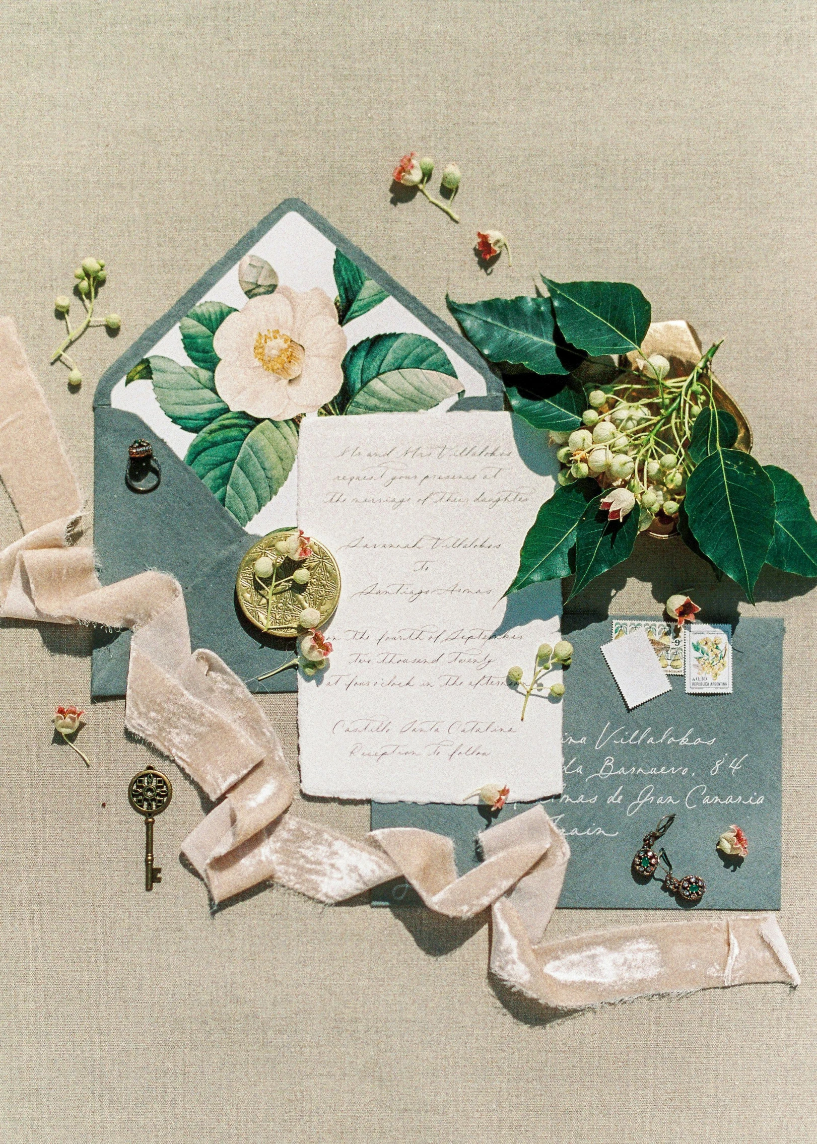 a piece of paper sitting on top of a table, by Natasha Tan, featured on instagram, exquisite floral details, muted color scheme, satin ribbons, conde nast traveler photo