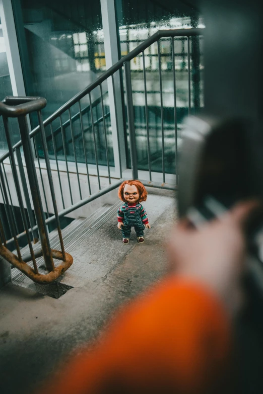 a person taking a picture of a child on a cell phone, a cartoon, pexels contest winner, chucky style, cinematic outfit photo, camera looking down into the maw, looking towards camera