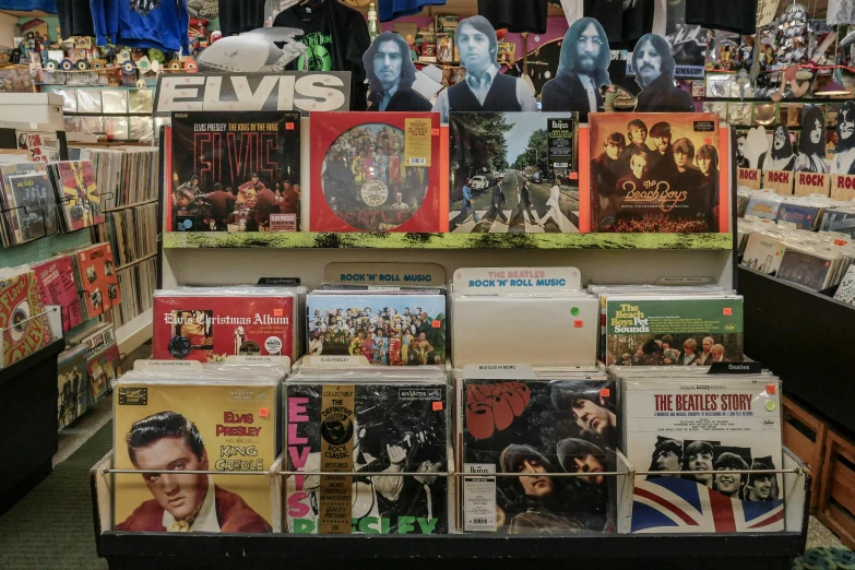 an assortment of vinyl records on display in a store, an album cover, by Joe Bowler, pexels, pop art, elvis, australia, thumbnail, rectangle
