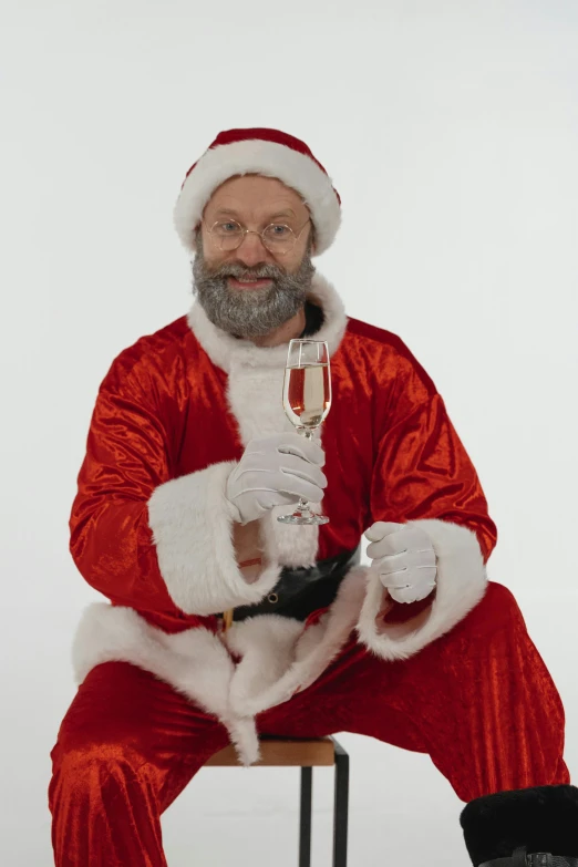 a man in a santa suit holding a glass of wine, chris cunningham, limmy, very long silver beard, 2 5 6 x 2 5 6 pixels