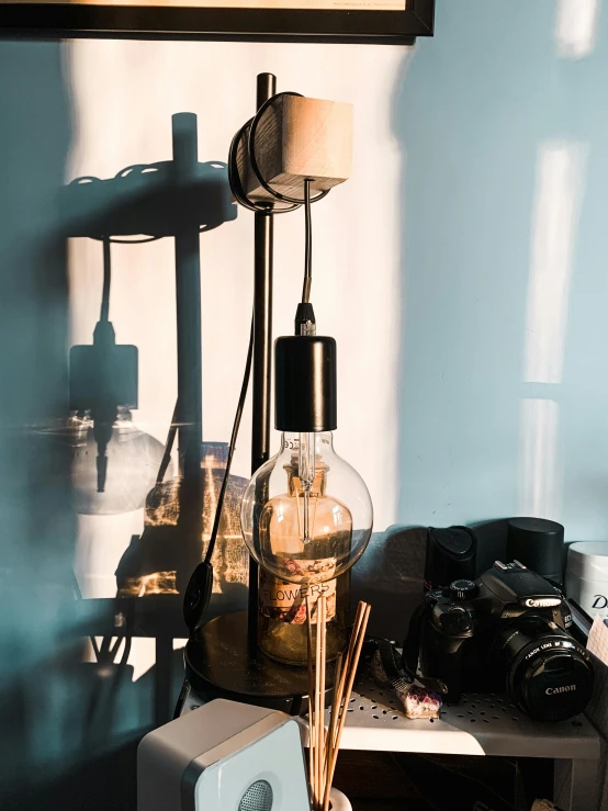 a lamp that is on top of a table, a picture, with a wooden stuff