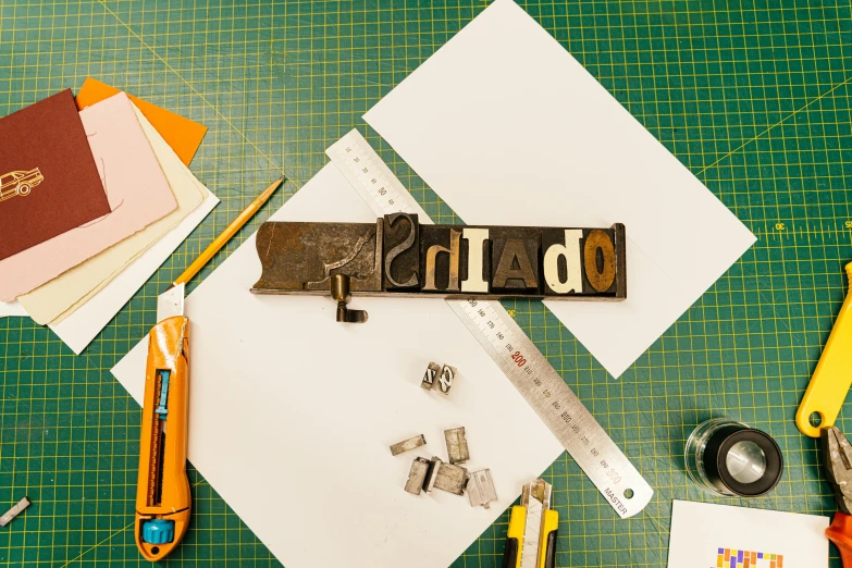 a variety of office supplies laid out on a table, a screenprint, inspired by Rinaldo Cuneo, trending on unsplash, private press, scrap metal on workbenches, detailed letters, todo hecho con papel de pinata, thumbnail