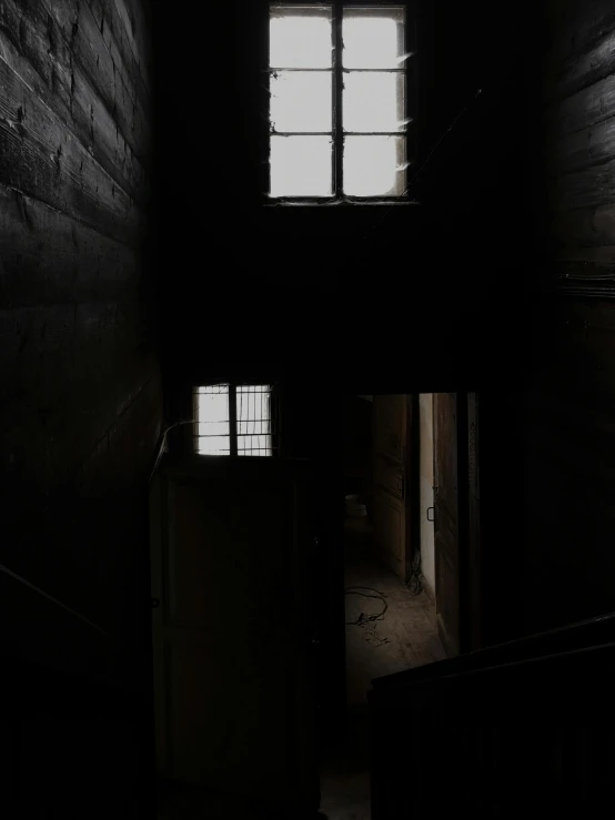 a light shines through a window in a dark room, inspired by Katia Chausheva, pexels contest winner, stairways, prison cell, low quality photo, scp-049