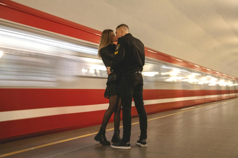 a man and a woman kissing in front of a train, streetwear, underground, profile image, fan favorite