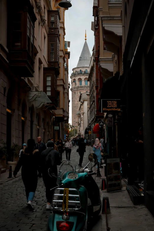 a group of people walking down a street next to tall buildings, by Cafer Bater, hurufiyya, neoclassical tower with dome, back alley, yes, street pic