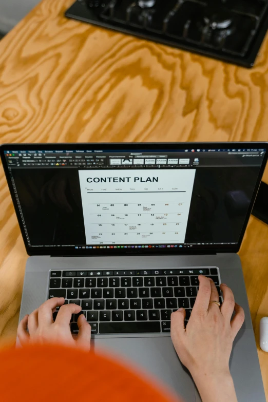 a person using a laptop on a wooden table, a computer rendering, by Dan Content, pexels, detailed plans and notes, meme format, presentation, plan