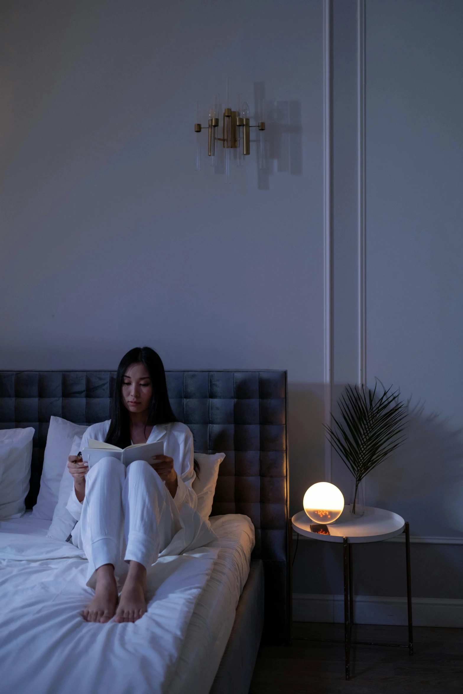 a woman sitting on a bed reading a book, inspired by Fei Danxu, global lighting, hanging out with orbs, night fill lighting, comfy lighting