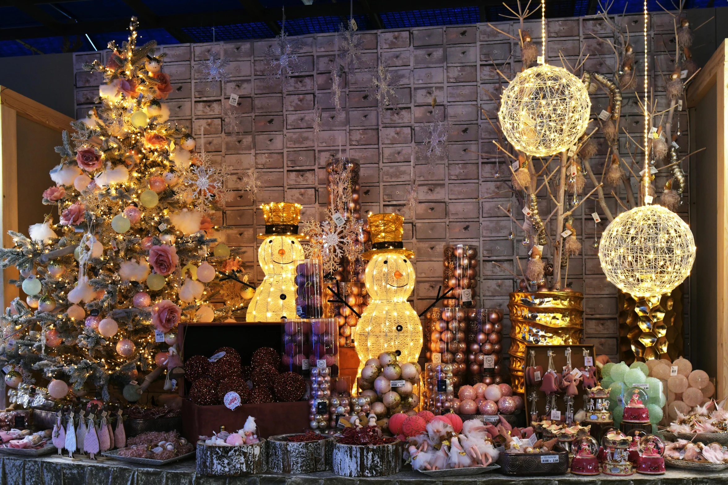 a table topped with lots of christmas decorations, pexels, happening, cotton candy trees, shades of gold display naturally, panoramic shot, in the spotlight