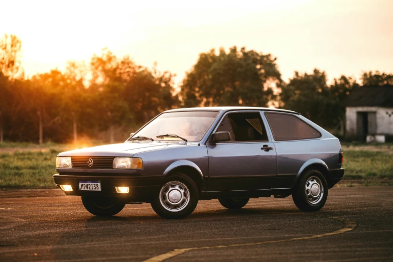 a small car is parked in a parking lot, an album cover, unsplash, iroc, soft evening lighting, triumphant, ah puch