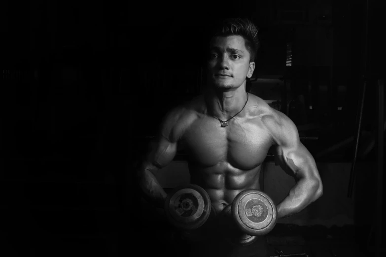 a man is posing for a black and white photo, a black and white photo, pexels contest winner, working out, hard lighting, symmetry!! full shot!!, mechanised