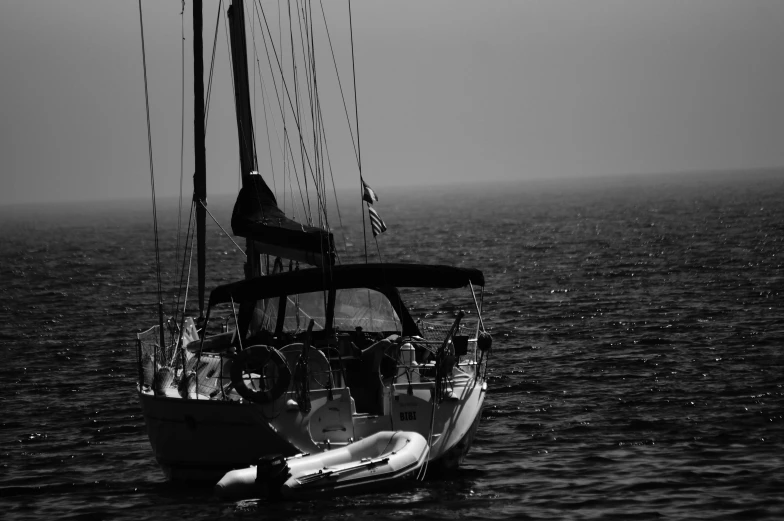 a black and white photo of a sailboat in the ocean, a black and white photo, unsplash, romanticism, greece, fog!!!, summer afternoon, watch photo