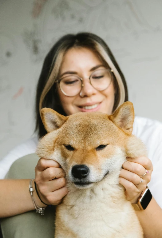 a woman sitting on a couch petting a dog, inspired by Shiba Kōkan, trending on pexels, modernism, headshot profile picture, japanesse farmer, on a gray background, headshot of young female furry