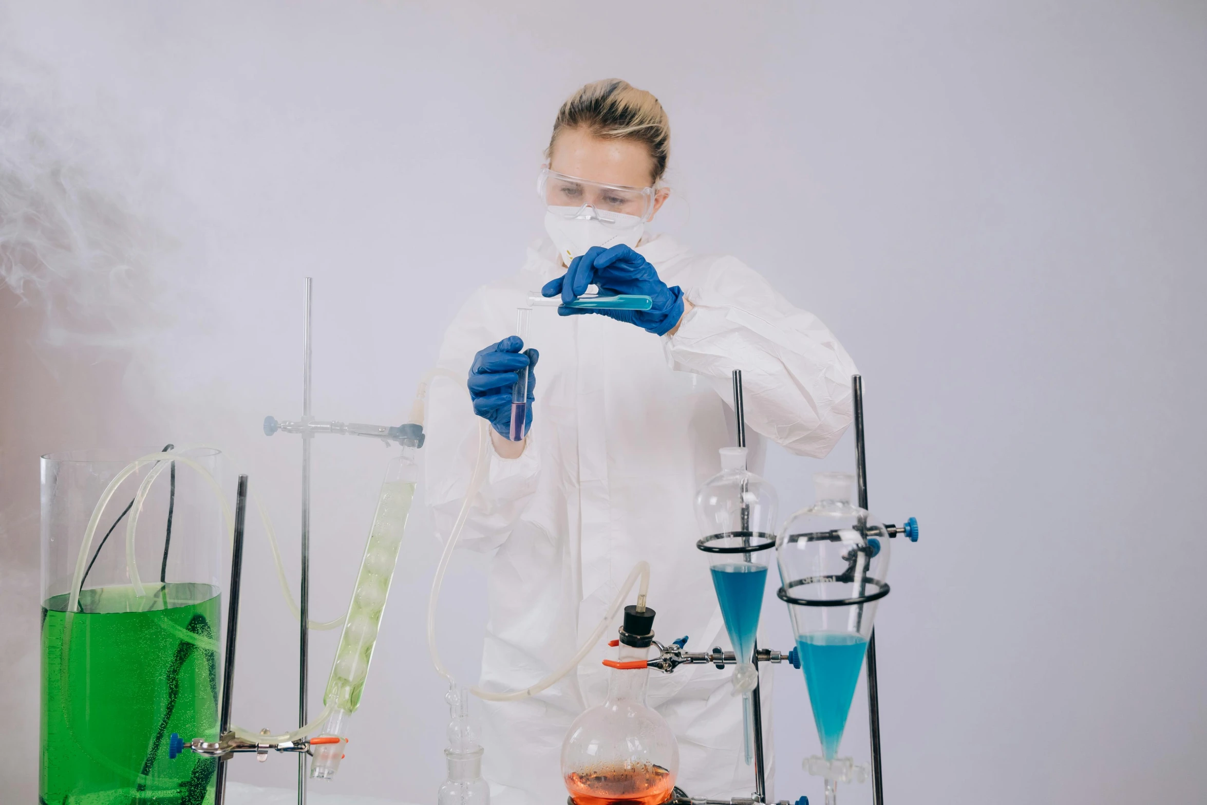 a woman in a lab coat is doing a chemical experiment, by Adam Marczyński, pexels, in front of white back drop, avatar image, surgical supplies, instagram picture