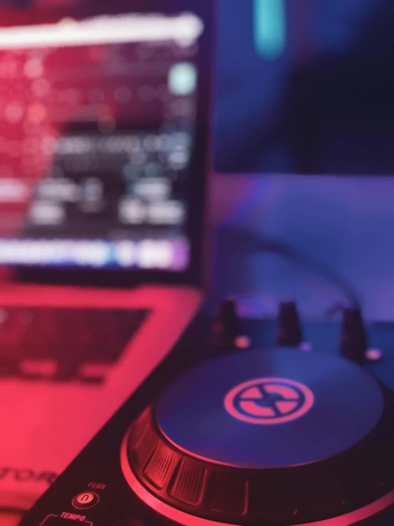 a laptop computer sitting next to a dj controller, trending on pexels, purple and red, avatar image, round format, club photography