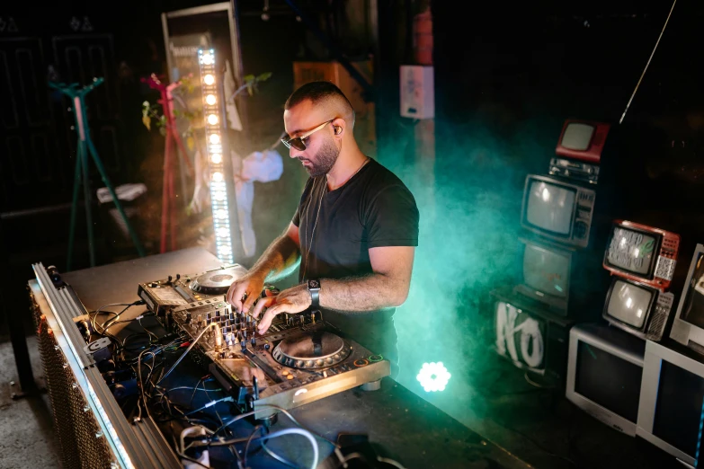 a man that is standing in front of a table, pexels contest winner, kitsch movement, dj at a party, profile image, karolina cummings, performing