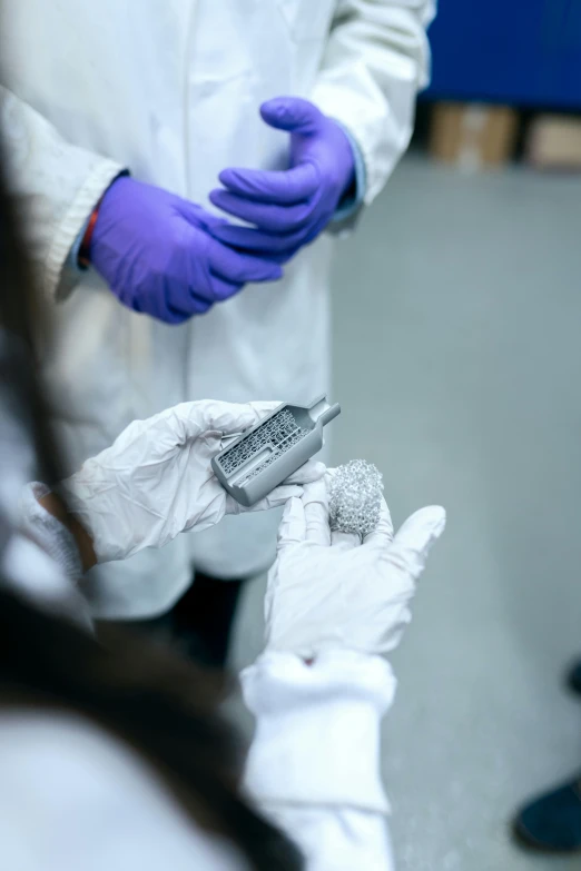 a person in a lab coat holding a cell phone, an engraving, reddit, cryogenic pods, high quality photo, bandage on arms, silver